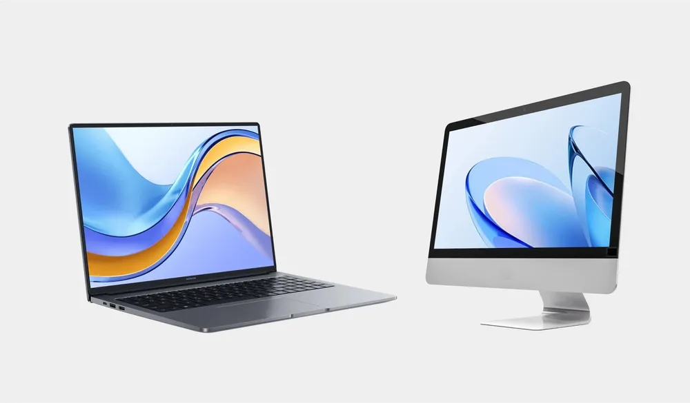 A laptop next to an all-in-one desktop